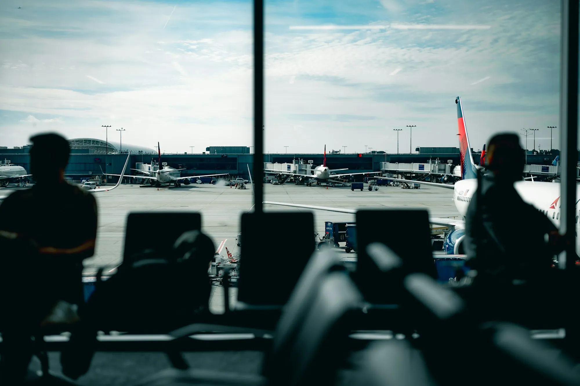 Travellers waiting at an airport departure gate